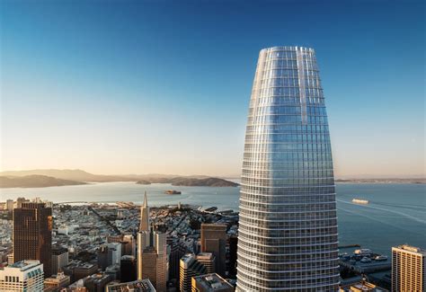 An Aerial View Of A Tall Skyscraper Next To The Ocean