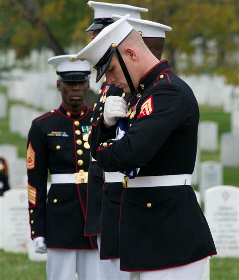 A Member Of The United States Marine Honor Guard Inspects A Carefully