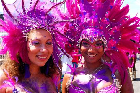 Two Women Dressed In Bright Pink And Purple Costumes