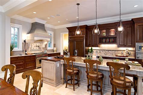 Source list 20 pendants that illuminate the kitchen island. Traditional Kitchen by In Detail Interiors