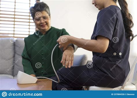 Doctor Or Nurse Using Blood Pressure Gauge With Old Women Patients