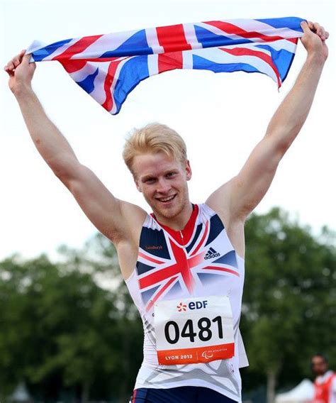 A Man Is Holding Up A British Flag