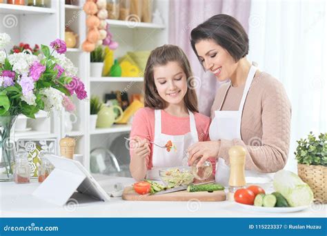 Smiling Mother And Daughter Cooking Together At Kitchen Stock Image Image Of Girl Lifestyle