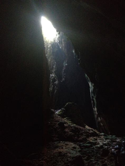 The Light Shines Brightly Through An Opening In A Cave