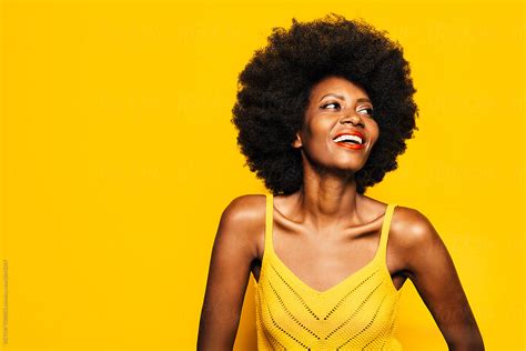 Happy Afro Woman Posing Over Yellow Background By Victor Torres