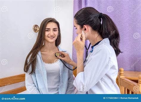 Doctor Listening Patient`s Heartbeat With Stethoscope In Hospital Stock