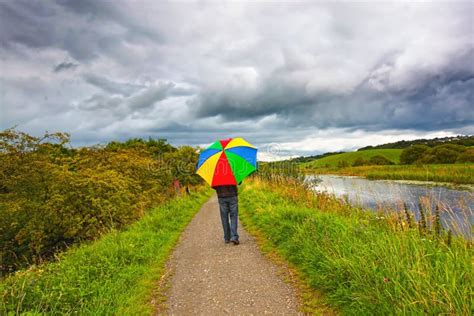 A Man Walking In The Rain Stock Image Image Of Protect 24163659