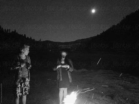 Two People Eating Around Campfire By Stocksy Contributor Kevin