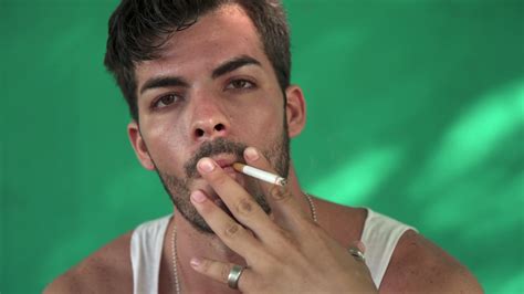 Young Hispanic Man Smoking Cigarette And Blowing Smoke Stock Video