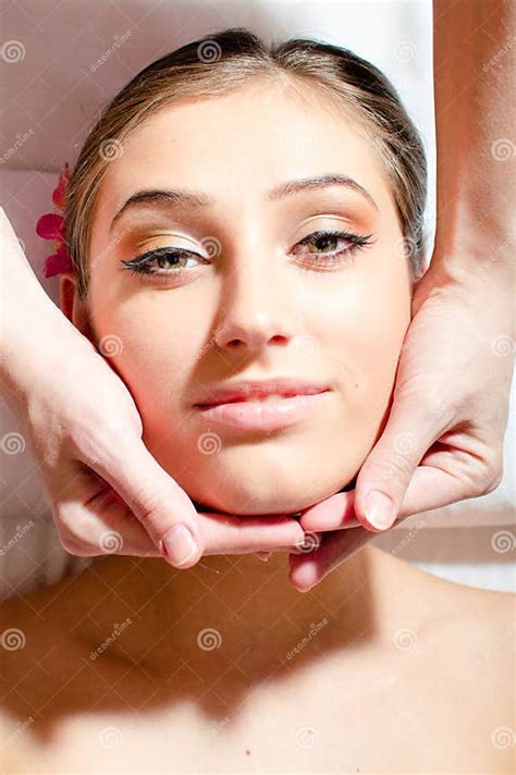 Closeup On Beautiful Nice Young Woman On Spa Treatments During Face Massage Relaxing And Looking
