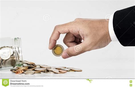 Hand Picking Up Coin From Spilled From Glass Jar Stock Image Image Of