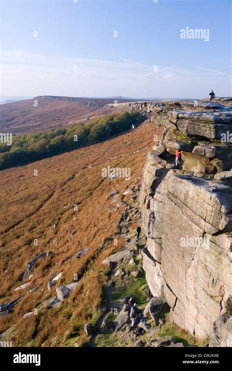 Climbers On Stanage Edge Gritstone Escarpment Cliff Overlooking