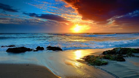 1920x1080 Oean Waves Sunset Sky Clouds Rocks Sea Beach Sand Beauty Nature