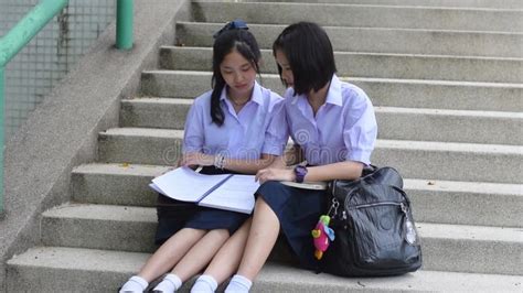 Asian Thai Schoolgirl Student In High School Uniform Is Wearing Her