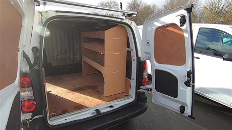 Fitting Of A Three Bar Roof Rack And Roller And Plywood Shelving Units