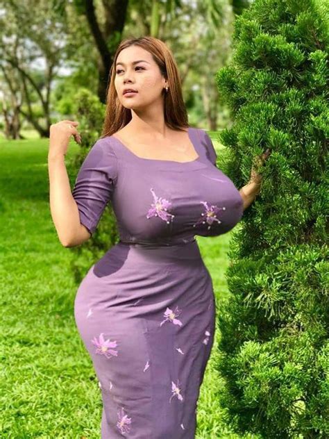 A Woman In A Purple Dress Posing For The Camera