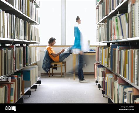 Teenage Boy Doing Homework In Library Stock Photo Alamy