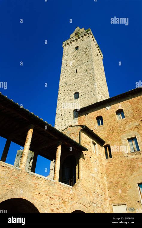 the torre grossa in the the courtyard of the palazzo del popolo in san gimignano tuscany stock