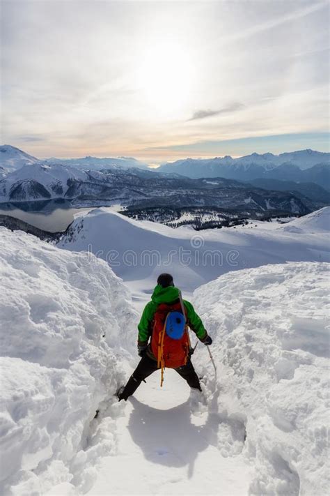 Adventurous Man Climbing Up A Steep Snowy Mountain Stock Image Image