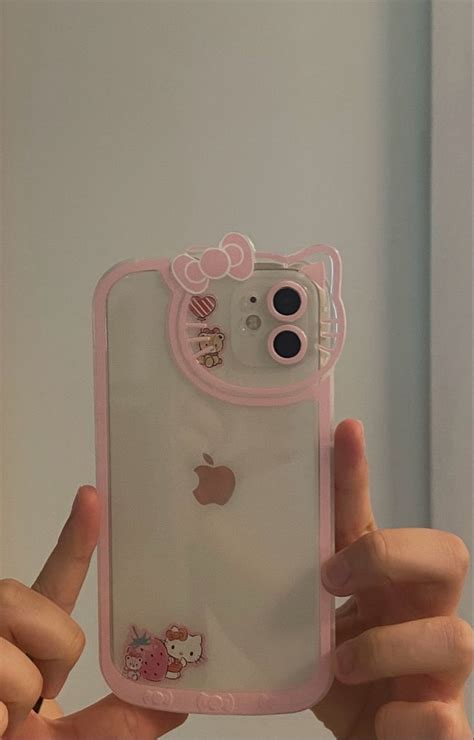 A Person Holding Up An Iphone Case With Hello Kitty Stickers On It