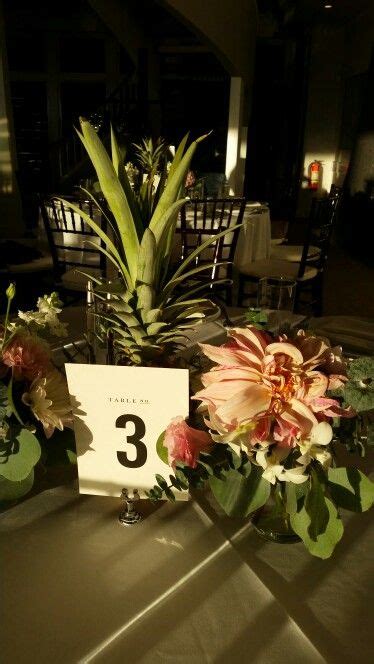There Is A Table With Flowers On It And A Sign That Says 3 In The Center