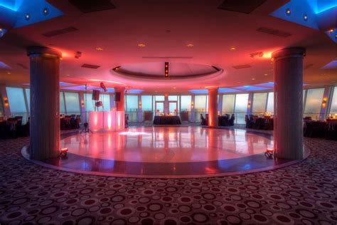 A Large Room With Columns And Lights On The Ceiling Is Lit Up By Red