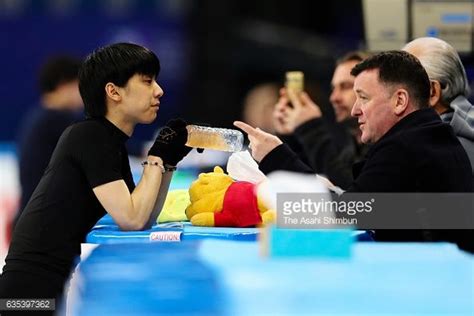 Yuzuru Hanyu of Japan talks with his coach Brian Orser during a practice session during day one ...
