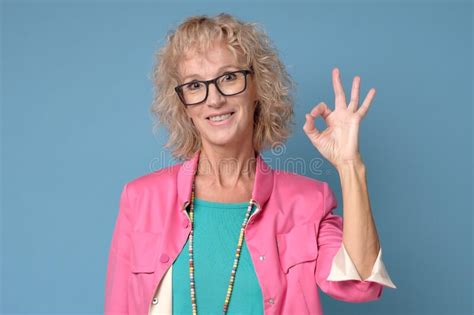Woman In Eyeglasses Showing Ok Sign To Express Appreciation Stock