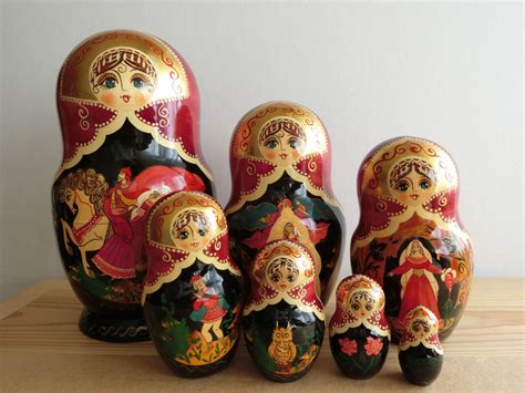 A Group Of Nesting Dolls Sitting On Top Of A Wooden Table