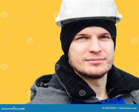 Large Portrait Of Man In Construction Helmet On Yellow Background