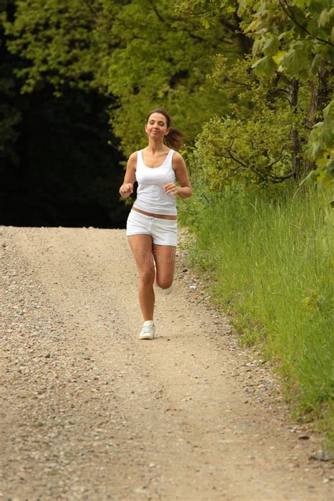 Young Woman Runner In A Green Forest Stock Photo Image Of Health
