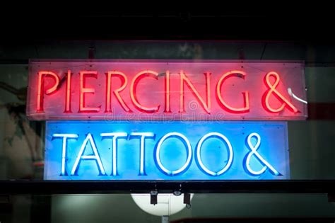 Neon Signboard With Piercing And Tattoo At Night Stock Photo Image Of