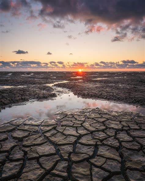 Setting Sun At Tidal Flats By The Wadden Sea The Netherlands Oc