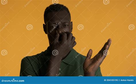 African American Man Pinching Nose Due To Bad Smell Isolated On
