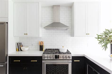 It also features as well as white upper cabinets and black base cabinets. Blue and White Two Toned Kitchen Cabinets - Bella Tucker