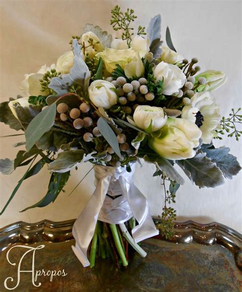 A Bouquet Of White Flowers And Greenery On A Tray
