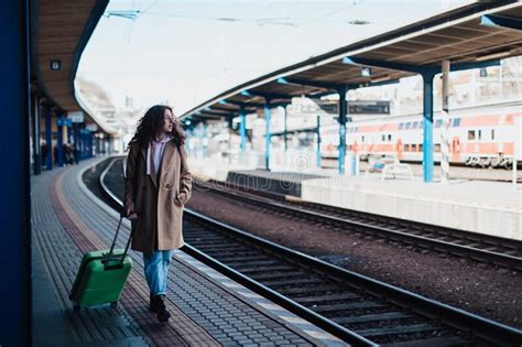 Happy Young Traveler Woman With Luggage Waiting For Train At Train Station Platform Stock Image