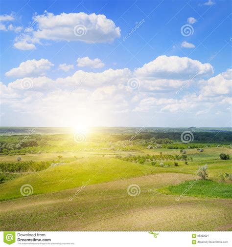 Hilly Terrain Spring Field And Sunrise On Blue Sky Stock Photo Image