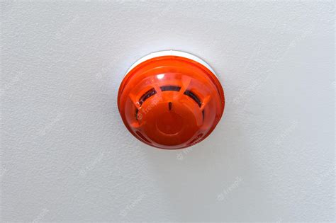 Premium Photo Smoke Detector With Plastic Cap Cover Mounted On