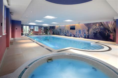 indoor pool with mural and spa
