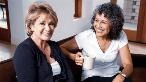 A Pair Of Mature Ladies Share Some Gossip Over A Cup Of Coffee The