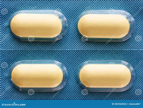 Four Yellow Oblong Pills In A Blister Stock Photo Image Of Oblong