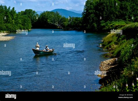 Two Fisherman Drifting Down The Saco River In North Conway Nh On A