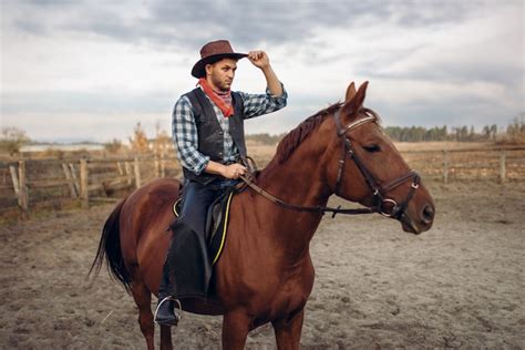 Premium Photo Cowboy In Leather Clothes Riding A Horse In Desert