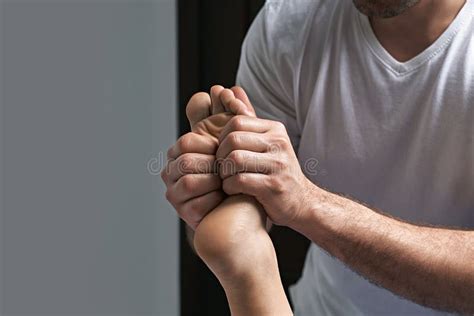 Male Masseur Hands Doing Reflexology Massage On Female Foot Reflex Zones In The Spa Salon Stock
