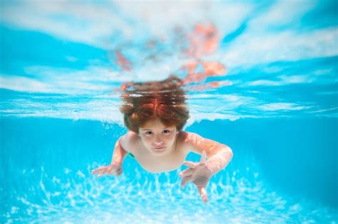 Летние дети в морской воде на пляже ребенок плавает в бассейне под
