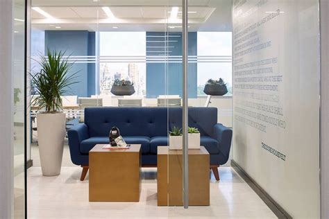 A New York Office Reception Area Is Completed With Blue Sofa Décor