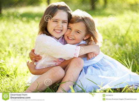 Seeing his pampered mother collapse, the boy gets carried away and decides to skip childhood in order to stand by her. Two Young Girls Hugging In Summer Field Stock Photo ...