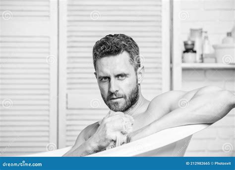 macho naked in bathtub wash off foam with water carefully sex and relaxation concept macho