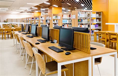 Computers And Bookshelves In Modern Library Stock Photo Download
